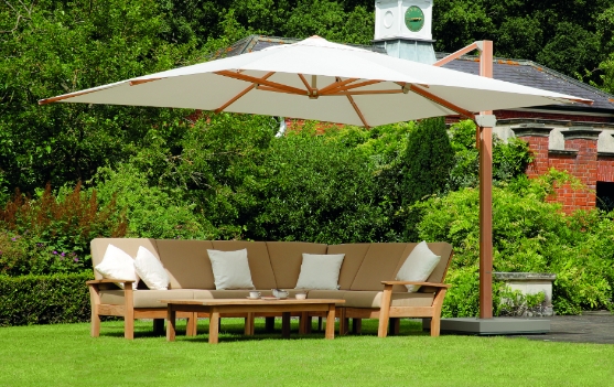 A large umbrella covering an outdoor sectional.