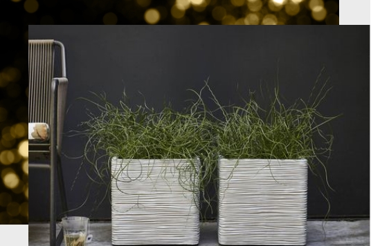 Two square planters next to a chair.
