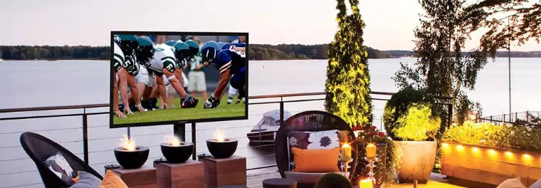 An outdoor TV mounted on a standing pole stand.