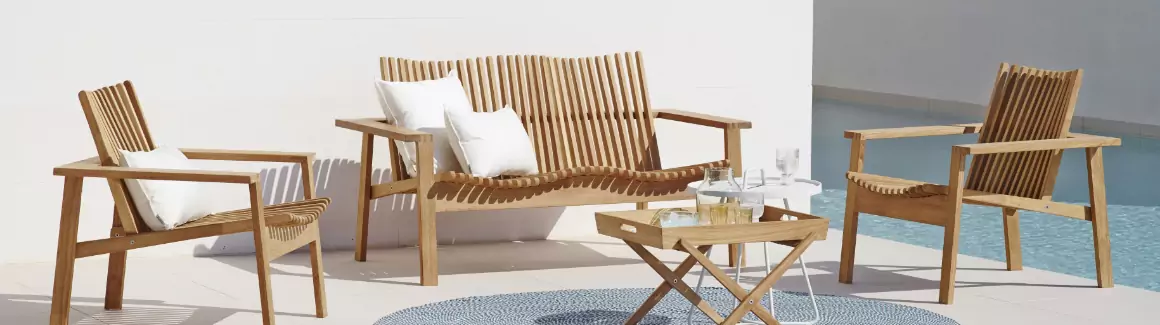 A teak living room set with two chairs, a sofa, and a small serving table.
