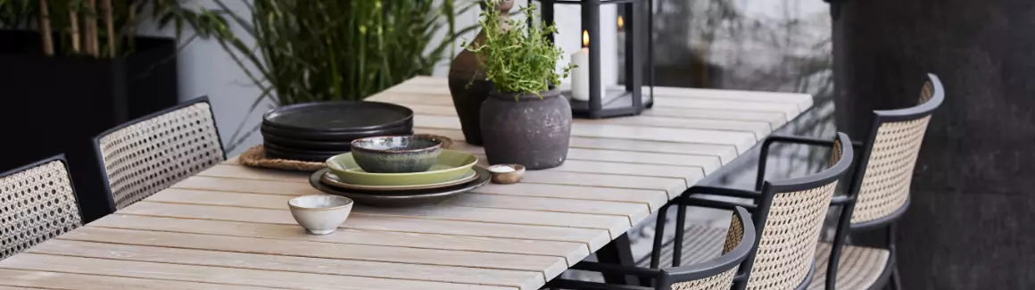 A teak dining table with chairs.
