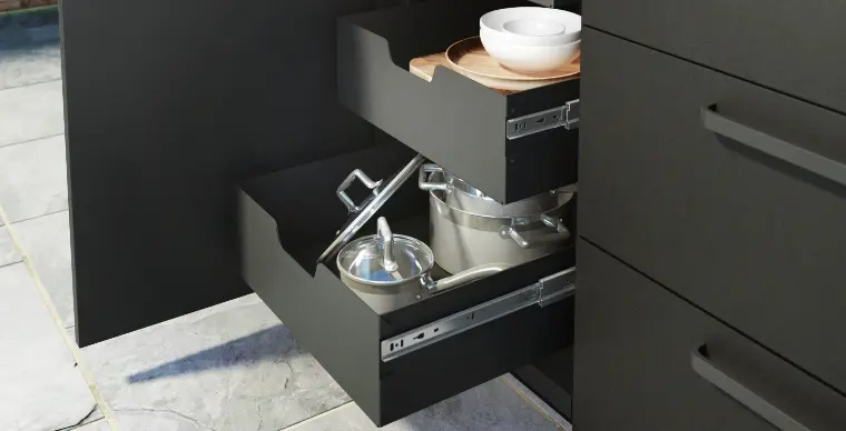 An outdoor kitchen with an open cabinet.