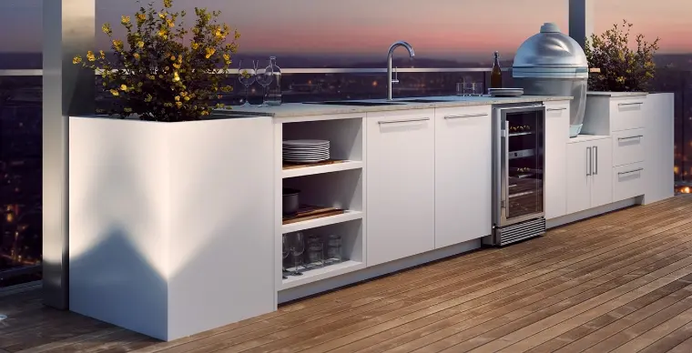 An outdoor kitchen with a built-in wine fridge.
