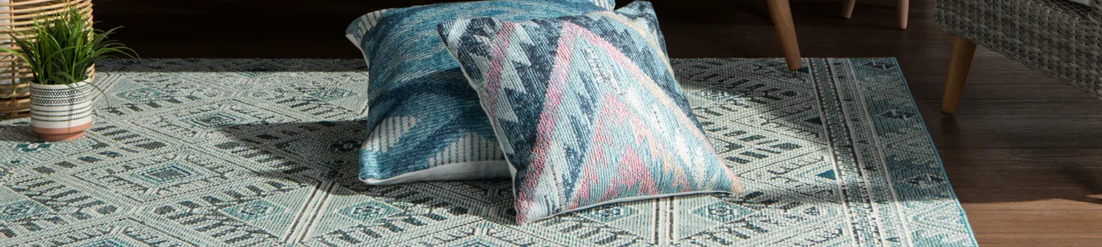 A rug under two pillows.
