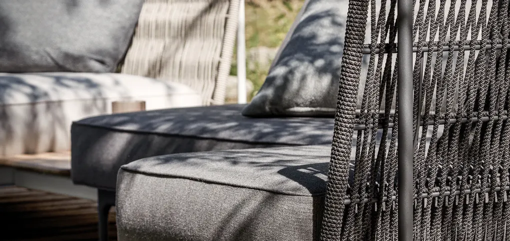 A gray sofa with some upholstered design.