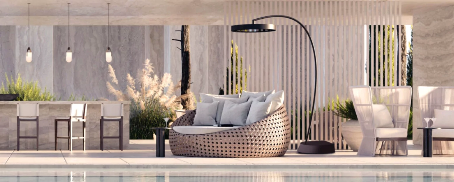 A standing heater by a large circular chair with various pillows.