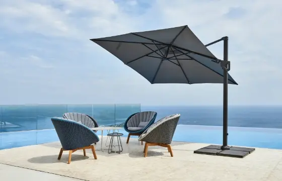 A large umbrella covering four chairs and a table.