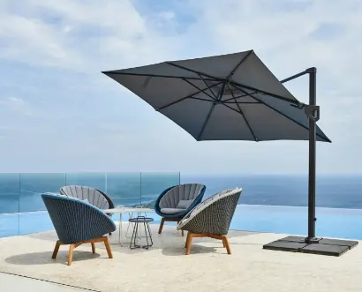 A large umbrella covering four chairs and a table.