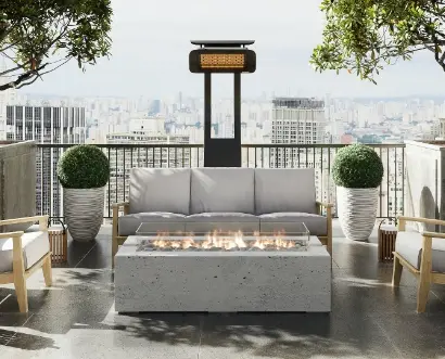 A rooftop sitting area with a fire table in the center, a sofa and two chairs around it.