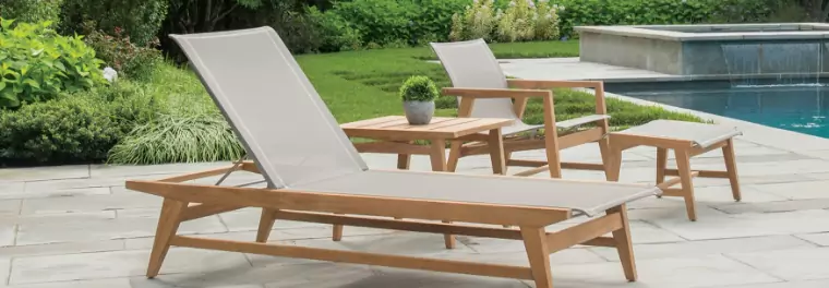 A lounger and a chair by a pool.