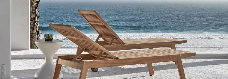 Two loungers in front of a beach.