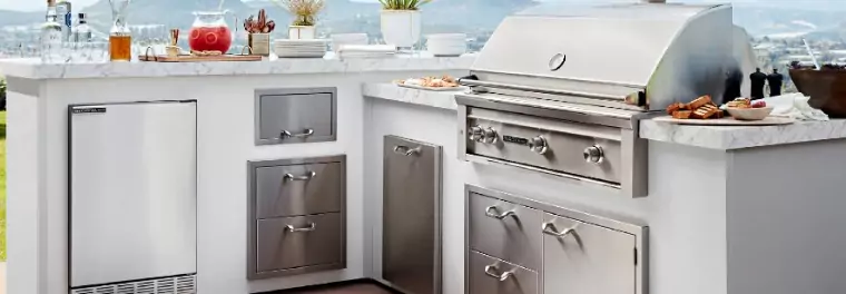 An outdoor kitchen with some built-in cabinets and drawers.