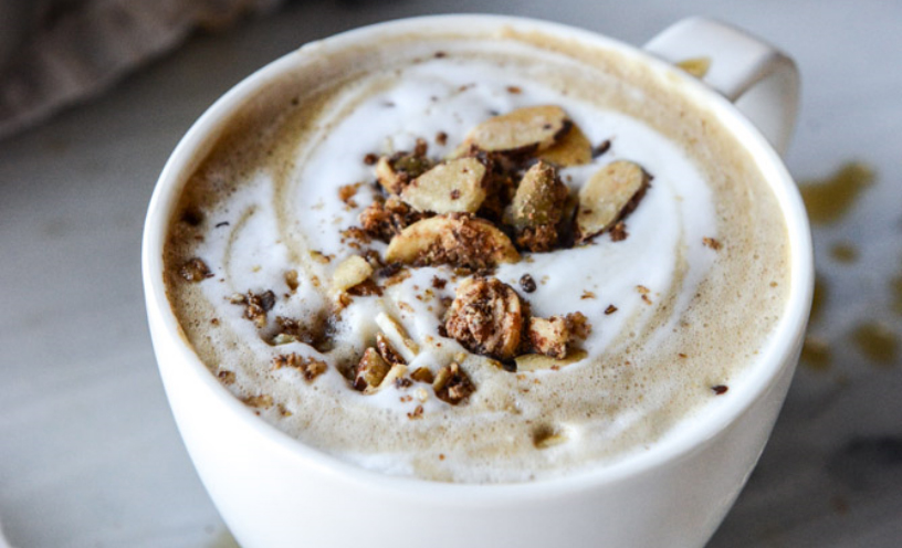 A cup of Oatmeal Cream Pie, a white and brown foamy drink with some nuts