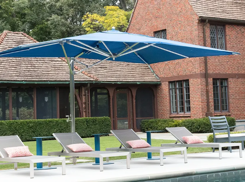 A large blue umbrella by a pool.