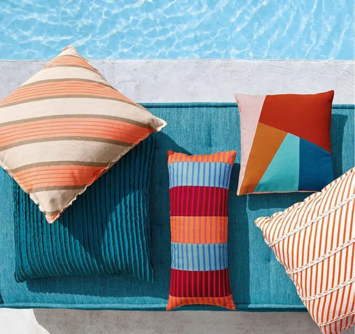 Various pillows by a pool