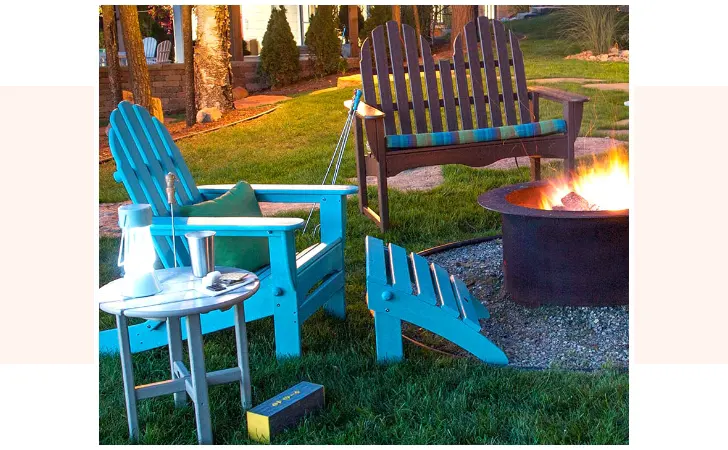 A few wooden chairs by a fire pit.