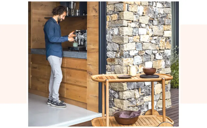 A man is pouring a cup of coffee from a machine.