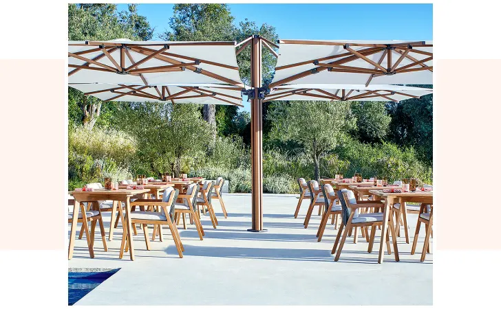 A large umbrella with various tables around it.