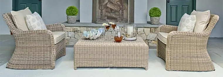 Two wicker sofas and a table.