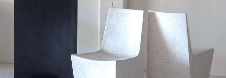 Two concrete dining chairs.