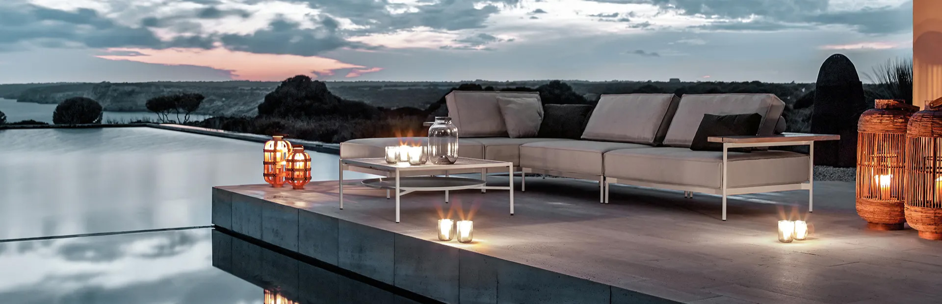 Metal Outdoor Sectional with a Coffee Table by a pool.
