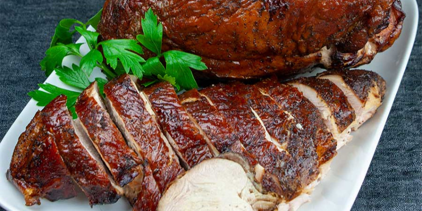 A smoked turkey served on a plate