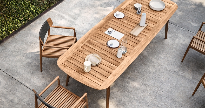 A teak dining table with four chairs