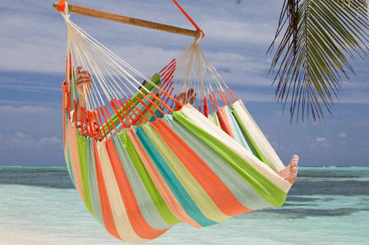 A person on a hammock on a beach