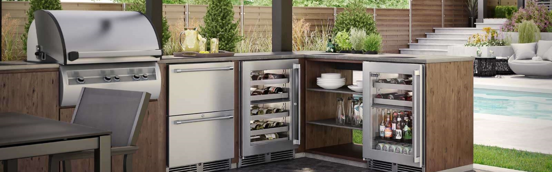 An outdoor kitchen with two wine coolers and a bbq.